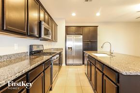 Peoria house for rent - A kitchen with brown cabinets and granite countertops.