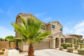 Peoria house for rent - a house with a palm tree in front of it