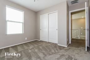 Peoria house for rent - a bedroom with two closets and a door to a staircase