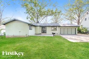 Florissant house for rent - A house with a green lawn and trees in the background.
