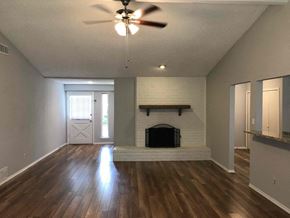 Flower Mound house for rent - a living room with a fireplace and a ceiling fan