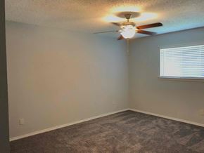 Flower Mound house for rent - a bedroom with a ceiling fan and a window
