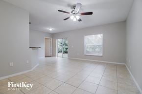 Sebastian house for rent - A spacious room with a ceiling fan and tiled flooring.