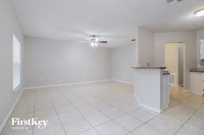 Sebastian house for rent - A spacious empty room with a kitchen area in the background.