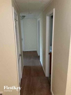 Joliet house for rent - A hallway with a wooden floor and white walls.