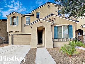 Peoria house for rent - a beige house with blue shutters and a garage door
