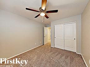 Peoria house for rent - the master bedroom has a ceiling fan and a closet