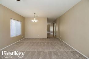 San Tan Valley house for rent - a spacious living room with beige walls and a carpeted floor