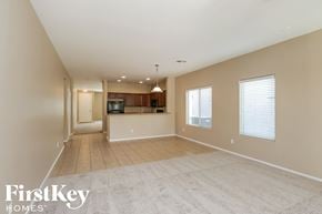 San Tan Valley house for rent - an empty living room with a kitchen in the background