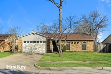 Grand Prairie house for rent - a brown brick house with a white garage door