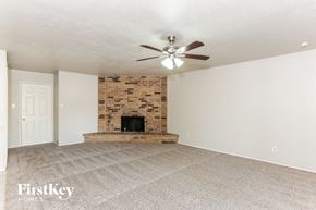 Grand Prairie house for rent - a living room with a fireplace and a ceiling fan