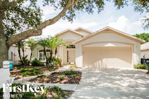 Valrico house for rent - a house with a driveway and a garage door