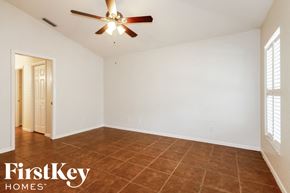 Valrico house for rent - a living room with white walls and a ceiling fan