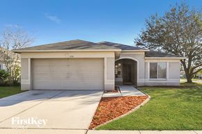 Riverview house for rent - a white house with a driveway and a garage door