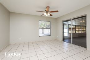 Orlando house for rent - A spacious room with a ceiling fan and sliding glass doors.