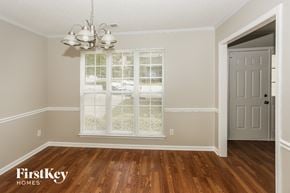 Charlotte house for rent - the living room after remodeling with hardwood flooring and a window