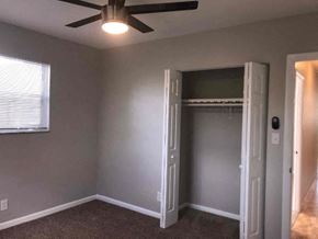 Hollywood house for rent - an empty bedroom with a ceiling fan and a closet