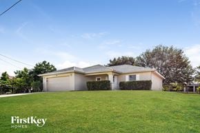 Cape Coral house for rent - a house with a lawn in front of it