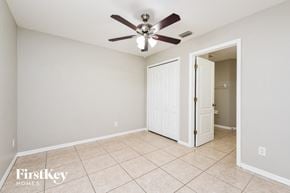 Cape Coral house for rent - the living room has a ceiling fan and tile flooring