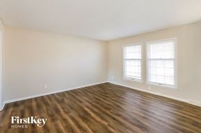 Lee's Summit house for rent - the living room of a home with wood flooring and two windows