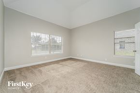 Lancaster house for rent - A room with a carpeted floor and a window showing a building outside.