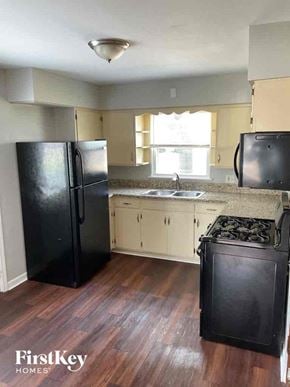 Joliet house for rent - an empty kitchen with a stove and a refrigerator