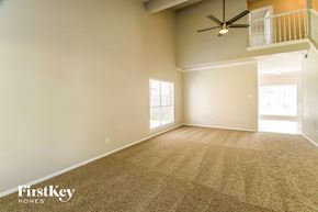 Missouri City house for rent - A room with a carpet floor and a ceiling fan.
