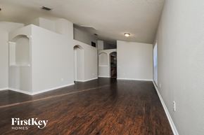 Riverview house for rent - A spacious room with wooden floors and white walls, with a FirstKey Homes logo in the corner.