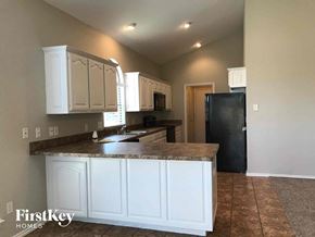 Crowley house for rent - a kitchen with white cabinets and a counter top