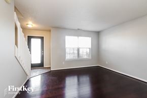 Fishers house for rent - an empty living room with wood floors and a window