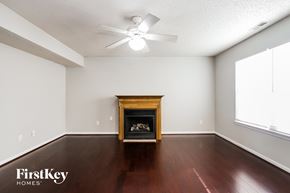Fishers house for rent - a living room with wood floors and a fireplace