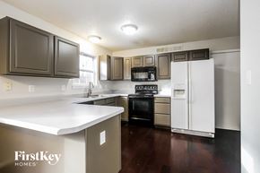 Fishers house for rent - a kitchen with white counter tops and stainless steel appliances