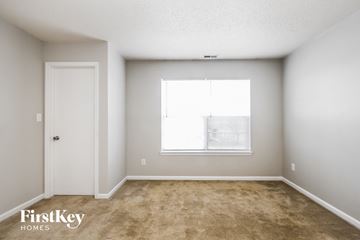 Fishers house for rent - the living room of an apartment with a window and carpet
