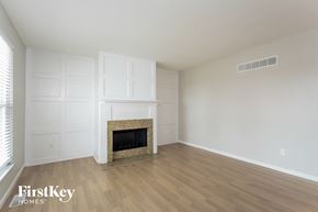 Saint Charles house for rent - A room with a fireplace and wooden floors.