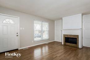 Saint Charles house for rent - A room with a fireplace and a door.