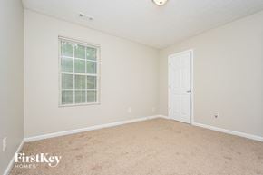Covington house for rent - a spacious bedroom with carpet and a door to the bathroom