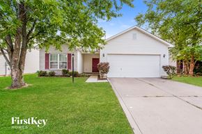 Fishers house for rent - a white house with red doors and a driveway