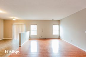 Fishers house for rent - an empty living room with wood floors and white walls