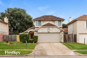 Stafford house for rent - a house with a white garage door and a lawn