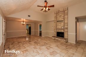 Stafford house for rent - a large living room with a fireplace and a ceiling fan