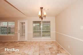 Stafford house for rent - a dining room with a large window and a chandelier