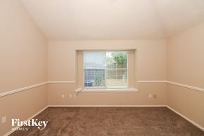 Stafford house for rent - a bedroom with a window and a carpeted floor