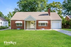Independence house for rent - A brick house with a white door and a chimney.