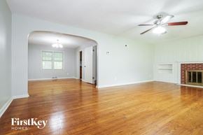 Independence house for rent - A room with wooden floors and a fireplace.