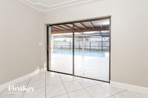Wellington house for rent - a sliding glass door leading to a swimming pool