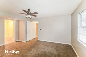 Lithonia house for rent - a living room with a carpet and a ceiling fan