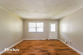 Indianapolis house for rent - A room with wooden floors and white walls.