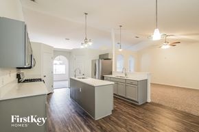 Jacksonville house for rent - a kitchen with white counter tops and stainless steel appliances