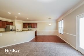 Charlotte house for rent - an empty living room and kitchen with a large window