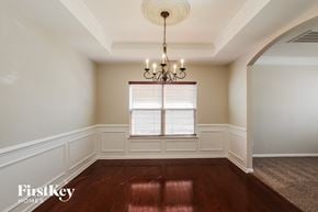Charlotte house for rent - a dining room with a chandelier and a window